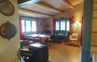 a dining room with a table and chairs in a cabin at Solbakken in Vikersund