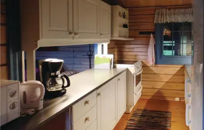 a kitchen with white cabinets and a counter top at Solbakken in Vikersund