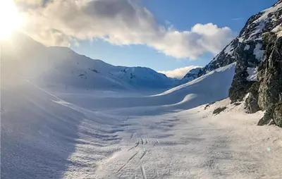 a snow covered mountain with the sun in the background at Amazing Home In Åmotsdal With Kitchen in Åmotsdal