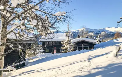 a house covered in snow in the mountains at Amazing Home In Åmotsdal With Kitchen in Åmotsdal
