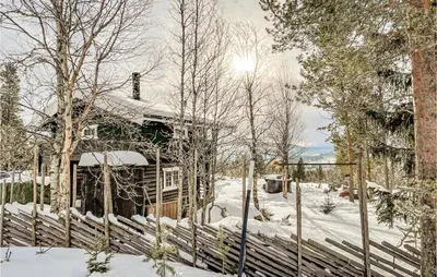 a house in the snow with a fence at Nice Home In Vinstra With Kitchen in Vinstra