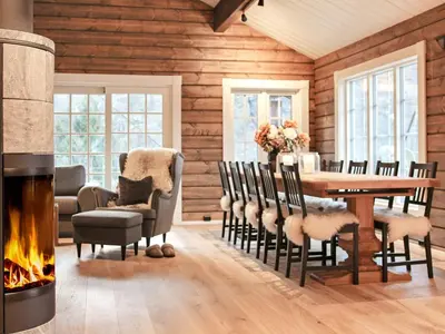 a dining room with a fireplace and a table and chairs at 9 person holiday home in Geiranger-By Traum in Geiranger