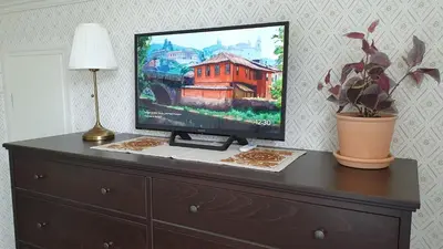 a flat screen tv sitting on top of a dresser at Trygheim feriehus in Bud