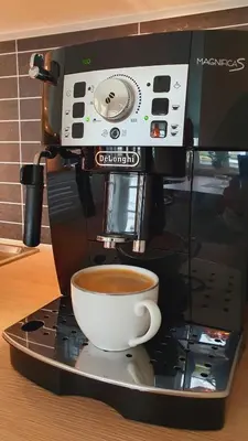 a cup of coffee sitting on top of a coffee machine at Trygheim feriehus in Bud
