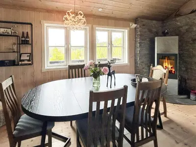 a dining room with a table and chairs and a chandelier at 10 person holiday home in veggli-By Traum in Veggli