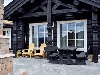 a picnic table and chairs outside of a house at 8 person holiday home in HURDAL-By Traum in Hurdal