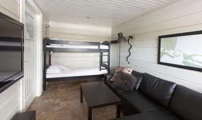 a living room with a couch and a bunk bed at Mosetertoppen Panorama anneks 1B in Hafjell