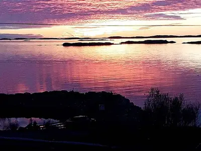 a sunset over a body of water with the sky at 6 person holiday home in MIDSUND-By Traum in Aukra