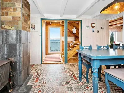 a dining room with a blue table and a view of the ocean at 6 person holiday home in MIDSUND-By Traum in Aukra