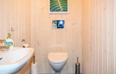a bathroom with a toilet and a sink at 4 Bedroom Nice Home In Sogndal in Sogndal