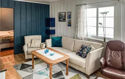 a living room with a couch and a table at Gorgeous Home In Svingvoll With Wifi in Svingvoll
