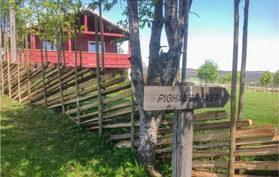 a sign in front of a house with a tree at Gorgeous Home In Svingvoll With Wifi in Svingvoll