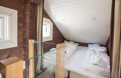 a small room with two beds in a attic at Hafjell tømmerhytte 4B in Hafjell