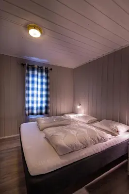a bedroom with a large bed in a room at Beito Resort Hytter in Beitostøl