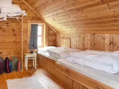 a log cabin with two beds in a room at 8 person holiday home in Ørskog-By Traum in Ørskog