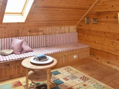 a log cabin with a bench and a table at 8 person holiday home in Ørskog-By Traum in Ørskog