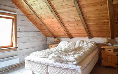 a bedroom with a bed in a wooden cabin at 6 Bedroom Beautiful Home In Vossestrand in Vossestrand