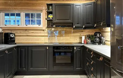 a kitchen with black cabinets and an oven at Cozy Home In Sjusjøen With Sauna in Sjusjøen