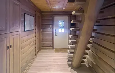 a hallway with wooden walls and a staircase in a house at Cozy Home In Sjusjøen With Sauna in Sjusjøen