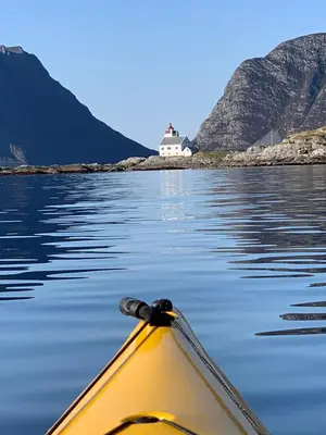 a kayak in the water with a house in the background at Torvholmen in Fosnavåg