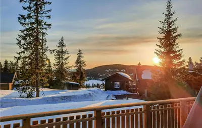 a winter sunrise on a deck with snow on the ground at Gorgeous Home In Lillehammer With Wifi in Lillehammer
