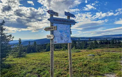 a sign on top of a hill in a field at Gorgeous Home In Lillehammer With Wifi in Lillehammer