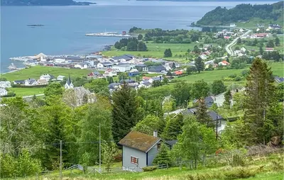 a small town on a hill with a body of water at 3 Bedroom Awesome Home In Leikanger in Leikanger