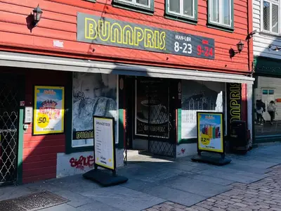 a store with signs in front of a building at Floien City House -free parking in Bergen