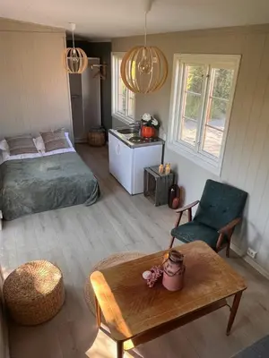 a bedroom with a bed and a table in a room at Drømmebrygga in Averoy