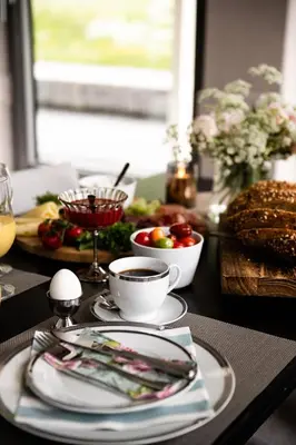 a table topped with plates and bowls of food at Moens Motell in Fiskå
