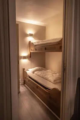 a bedroom with two bunk beds in a room at Bergo Leiligheter in Beitostøl