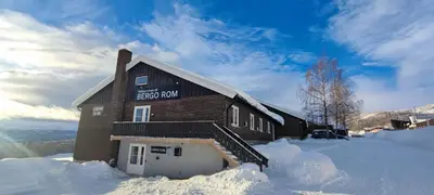 a building with a sign on it in the snow at Bergo Rom in Beitostøl