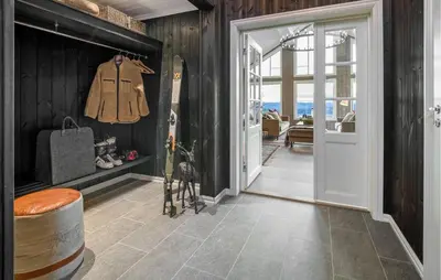 a hallway with a door leading to a room at Nice Home In Øyer With Kitchen in Øyer