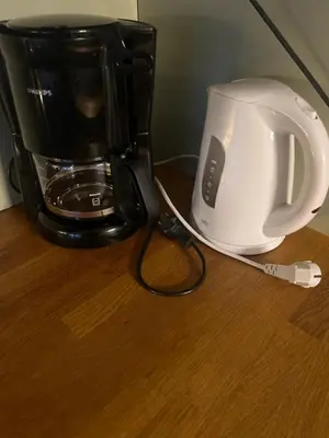 a coffeemaker and a coffee maker on a table at Fin leilighet ca 30 min med bil til Hunderfossen in Favang