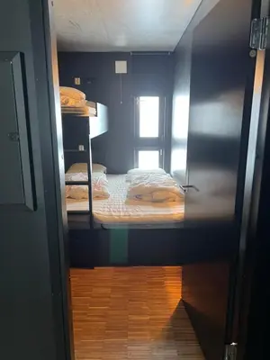 a small room with two bunk beds in it at Fin leilighet ca 30 min med bil til Hunderfossen in Favang