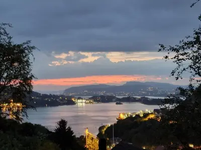 a view of a large river at night at Ibsens in Bergen