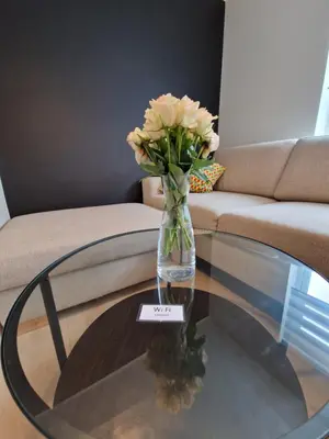 a vase of flowers sitting on a glass table at Ibsens in Bergen