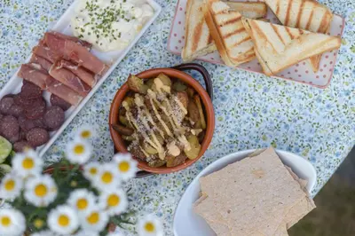 a table topped with a plate of food and crackers at Kyrkjestølen B&B in Tyinkrysset