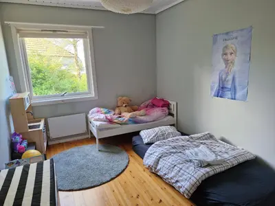 a bedroom with a bed and a teddy bear at Beautiful Villa with amazing view in Bergen. in Bergen