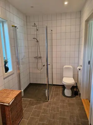 a bathroom with a shower and a toilet in it at Beautiful Villa with amazing view in Bergen. in Bergen
