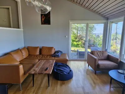 a living room with a couch and a table at Beautiful Villa with amazing view in Bergen. in Bergen