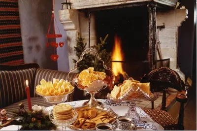 a table with a buffet of food in front of a fireplace at Glomstad Gjestehus in Tretten