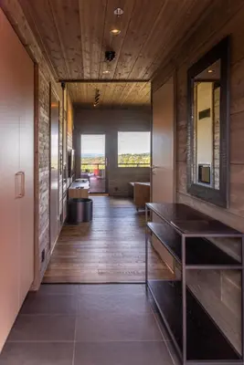 a hallway of a house with wooden floors and windows at Mosetertoppen Skiline - Hafjell Ski Resort in Øyer