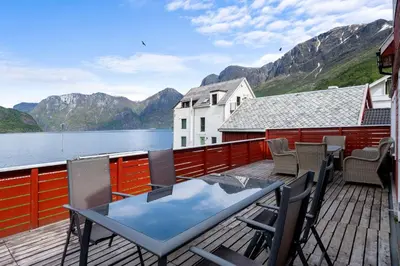 a balcony with a table and chairs and a view of the water at Aurland Guesthouse in Aurland
