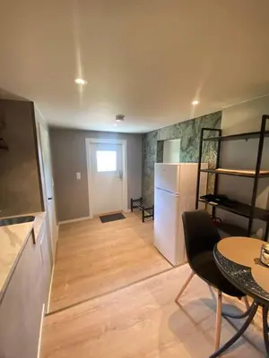 a living room with a refrigerator and a table at Vikavegen Stryn in Stryn