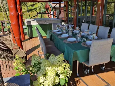 a long table with a green table cloth and chairs at DaVita Ranch in Tranhaug