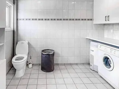 a bathroom with a toilet and a trash can at 8 person holiday home in Halsanaustan-By Traum in Korsnes