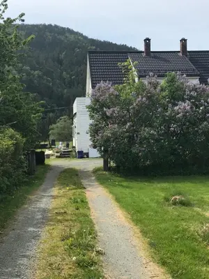 an rv parked on a dirt road next to a house at Dr Haave- middle of nowhere, pikeværelset in Sand