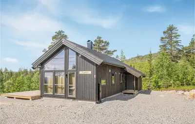 a large wooden building with a lot of windows at Awesome Home In Rena With Wifi in Rena