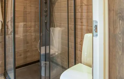 a bathroom with a glass shower with a toilet at Awesome Home In Rena With Wifi in Rena